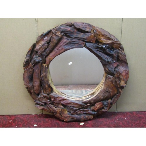 1321 - A rustic timber framed wall mirror of circular form with stained finish, 70 cm diameter.