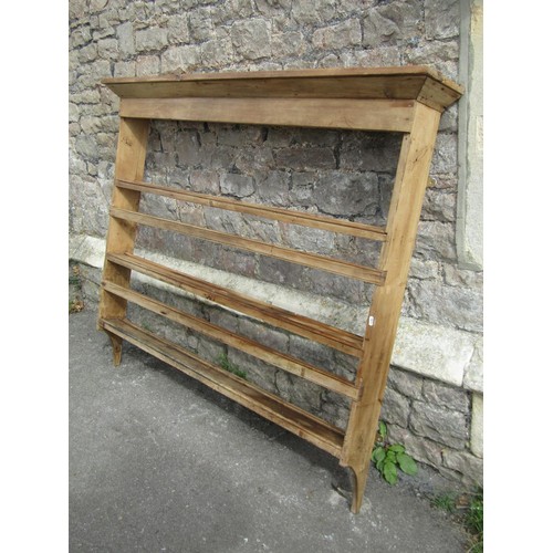 1324 - A rustic stripped pine wall mounted plate rack, probably Irish, 129cm high x 157cm wide