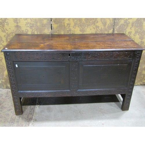 1326 - An antique oak coffer with hinged lid, panelled frame and carved frieze, 72cm high x 122cm x 51cm ap... 