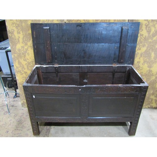 1326 - An antique oak coffer with hinged lid, panelled frame and carved frieze, 72cm high x 122cm x 51cm ap... 