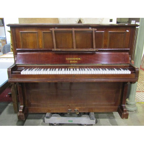 1325 - A C. Bechstein Berlin iron framed upright and over strung piano stamped 12505 and 7183F, together wi... 