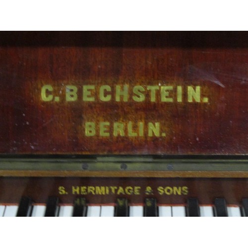 1325 - A C. Bechstein Berlin iron framed upright and over strung piano stamped 12505 and 7183F, together wi... 