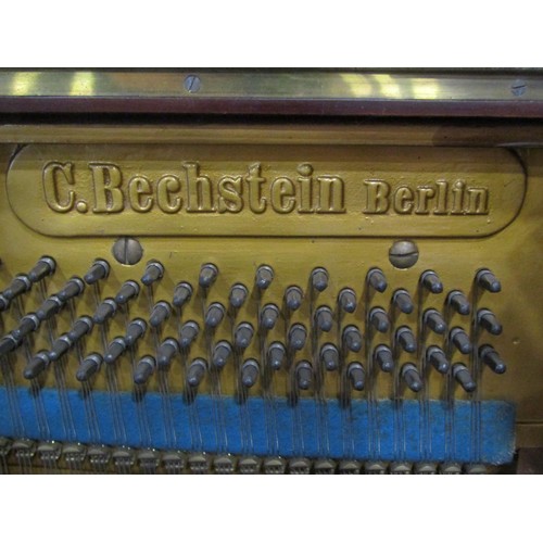 1325 - A C. Bechstein Berlin iron framed upright and over strung piano stamped 12505 and 7183F, together wi... 