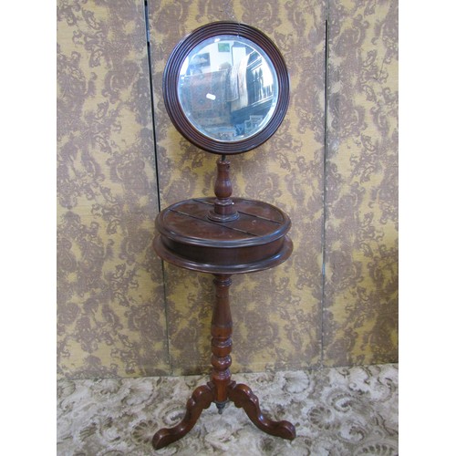 1239 - A Victorian mahogany shaving stand with adjustable circular bevelled edge mirror plate over a box co... 