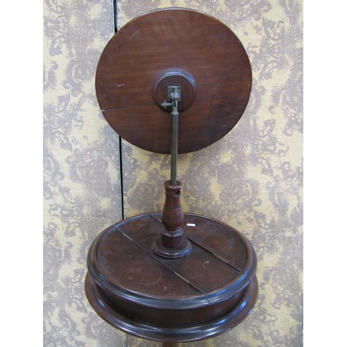 1239 - A Victorian mahogany shaving stand with adjustable circular bevelled edge mirror plate over a box co... 