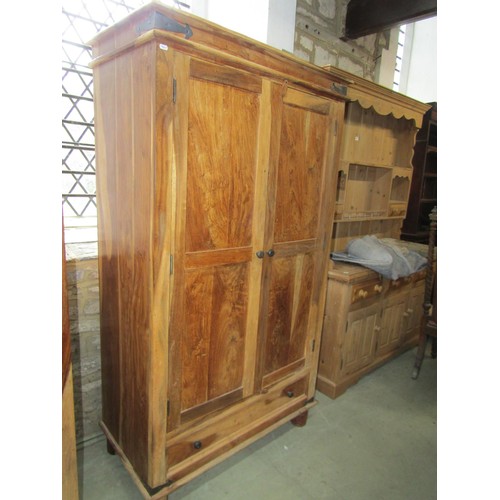 1284 - An Indian hardwood wardrobe enclosed by a pair of panelled doors over a long drawer, 180cm high x 10... 