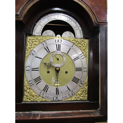 1344 - A Georgian mahogany longcase clock the hood enclosing a broken arch dial with silvered chapter ring,... 