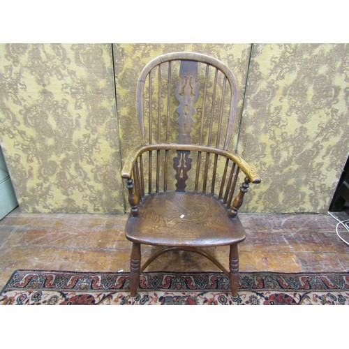 1350 - A Georgian Windsor elbow chair in elm, yew and ash wood with crinoline stretcher