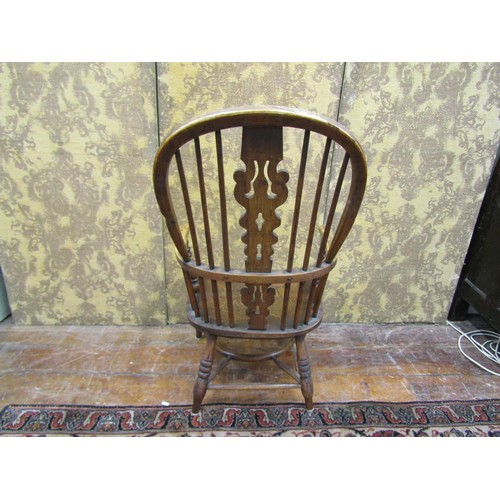 1350 - A Georgian Windsor elbow chair in elm, yew and ash wood with crinoline stretcher