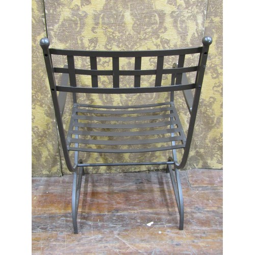 1359 - A contemporary steel X framed elbow chair