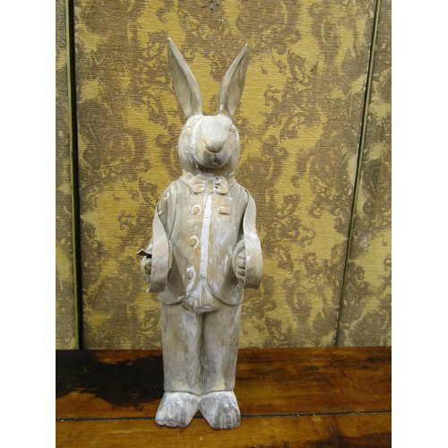 1381 - A free standing carved wooden model of a suited rabbit, 68cm high