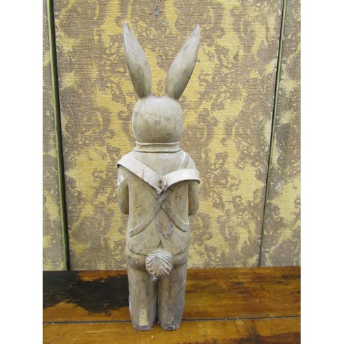 1381 - A free standing carved wooden model of a suited rabbit, 68cm high