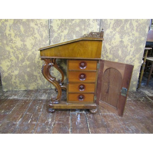 1382 - A Victorian figured walnut davenport of usual form with cabriole supports and gilt tooled leather to... 