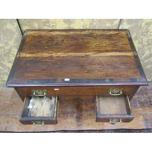 1389 - A Georgian oak country made low boy of three drawers to a central arch on chamfered supports, 76cm w... 