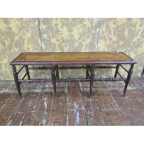 1390 - A 19th century beechwood and cane work window seat on eight turned supports united by turned rails, ... 