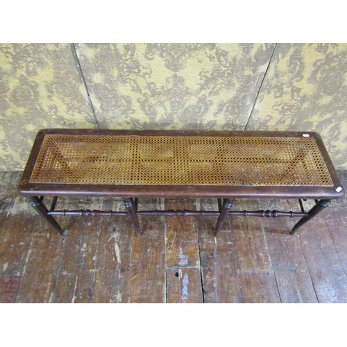 1390 - A 19th century beechwood and cane work window seat on eight turned supports united by turned rails, ... 