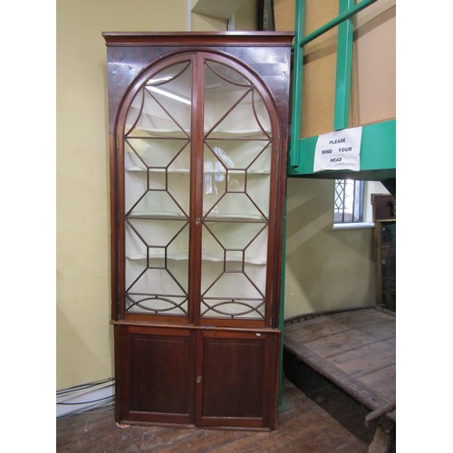 1399 - A good quality Georgian mahogany corner display cabinet the upper section enclosed by a pair of astr... 