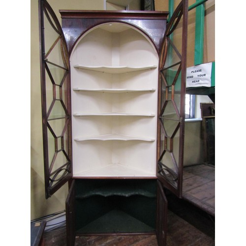 1399 - A good quality Georgian mahogany corner display cabinet the upper section enclosed by a pair of astr... 