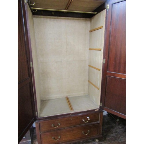 1400 - An Edwardian mahogany wardrobe of neat proportions, enclosed by a pair of panelled doors over two fr... 