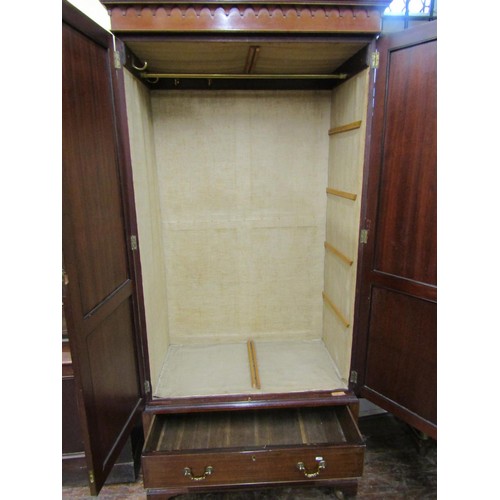 1400 - An Edwardian mahogany wardrobe of neat proportions, enclosed by a pair of panelled doors over two fr... 