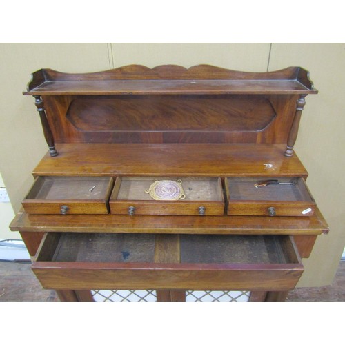 1401 - A Regency mahogany chiffonier enclosed by a pair of open doors with brass grille detail, flanked by ... 