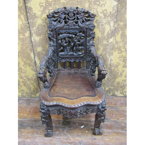 1411 - A 19th century carved Chinese hardwood elbow chair, profusely decorated with dragons, characters, sc... 