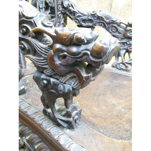 1411 - A 19th century carved Chinese hardwood elbow chair, profusely decorated with dragons, characters, sc... 