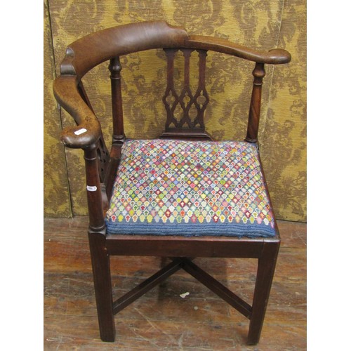 1412 - A Georgian walnut corner chair with Gothic tracery splats and hand worked tapestry seat