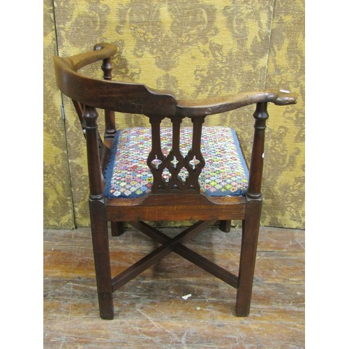 1412 - A Georgian walnut corner chair with Gothic tracery splats and hand worked tapestry seat