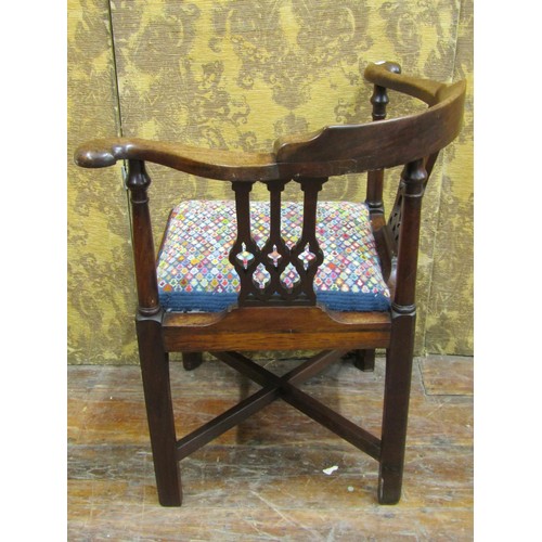 1412 - A Georgian walnut corner chair with Gothic tracery splats and hand worked tapestry seat