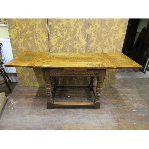 1408 - A good quality old English style oak draw leaf dining table of small proportions on turned supports,... 