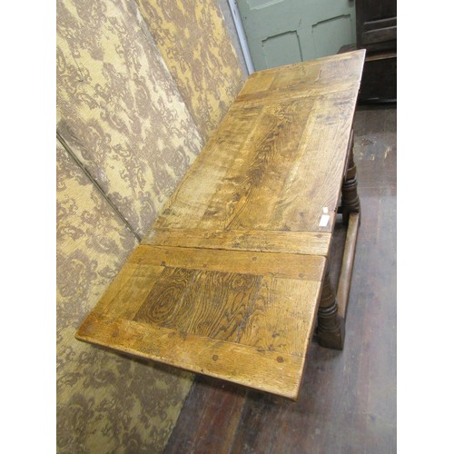 1408 - A good quality old English style oak draw leaf dining table of small proportions on turned supports,... 