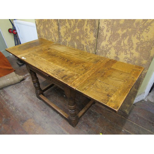 1408 - A good quality old English style oak draw leaf dining table of small proportions on turned supports,... 