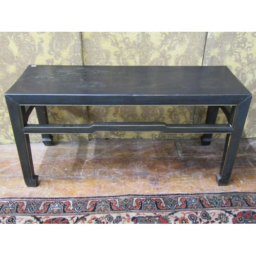 1419 - A Chinese occasional table of rectangular form with ebonised finish, 55cm high x 110cm x 38cm