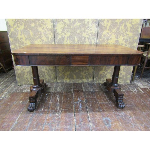 1426 - A Regency rosewood library table fitted with two frieze drawers, the stretcher base with lions paw t... 