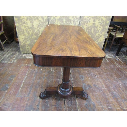 1426 - A Regency rosewood library table fitted with two frieze drawers, the stretcher base with lions paw t... 