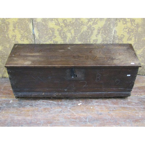 1433 - An oak boarded coffer monogrammed W B 1729, with steel lock plate and hasp, 103cm long