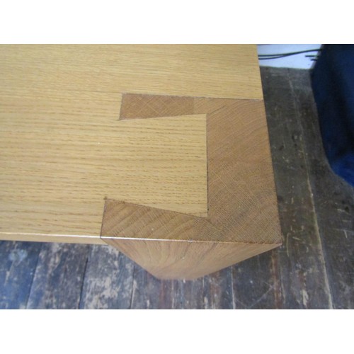 1437 - A contemporary oak dining table to seat six, on square cut supports with exposed dovetail joints, 18... 