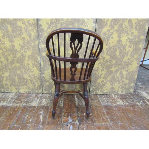 1446 - A Georgian Windsor chair principally in ashwood with crinoline stretcher