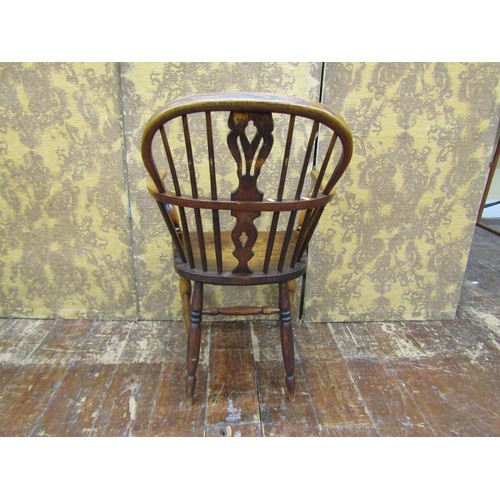 1447 - A Georgian Windsor elm and ashwood elbow chair, with pierced splat