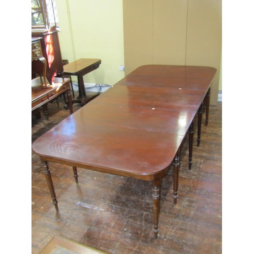 1448 - A regency mahogany dining table in three sections and with two additional leaves raised on twelve tu... 