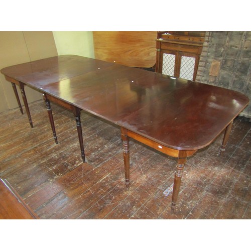 1448 - A regency mahogany dining table in three sections and with two additional leaves raised on twelve tu... 