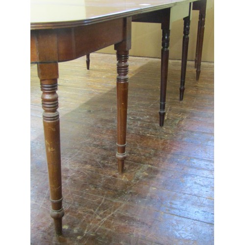 1448 - A regency mahogany dining table in three sections and with two additional leaves raised on twelve tu... 