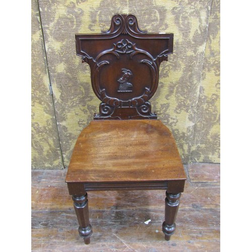 1453 - A regency mahogany hall chair with carved and shaped back, geometric detail and military figure