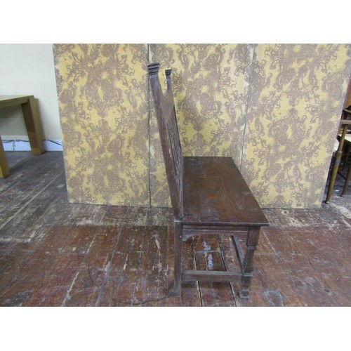 1455 - An Arts & Crafts oak hall settle with repeating vase shaped splats over a solid seat on shaped suppo... 