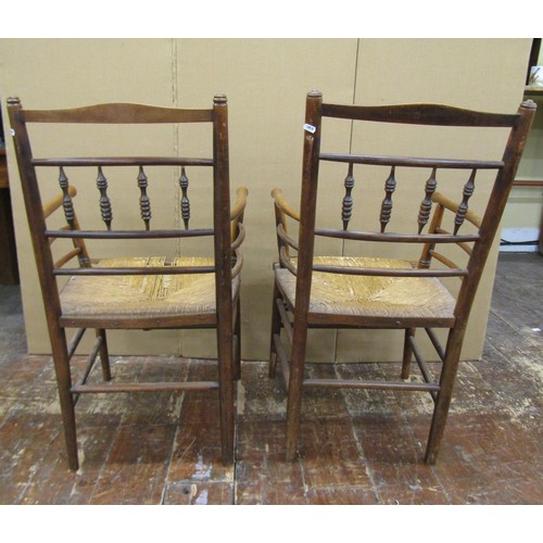 1456 - A pair of Sussex style armchairs in beechwood with rush seats, together with a matching single chair