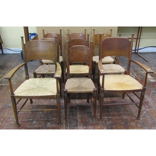 1458 - A set of nine (7+2) Arts & Crafts dining chairs by William Birch in oak with panelled back and rush ... 