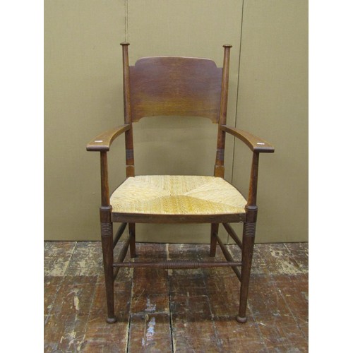 1458 - A set of nine (7+2) Arts & Crafts dining chairs by William Birch in oak with panelled back and rush ... 