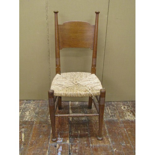 1458 - A set of nine (7+2) Arts & Crafts dining chairs by William Birch in oak with panelled back and rush ... 