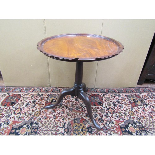 1460 - A Georgian mahogany tripod table with shaped outline on gun barrel pillar and tripod, 60cm diameter